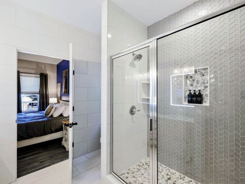 Primary Bath - Walk-in shower and bright finishes make this ensuite feel more spa than functional.
