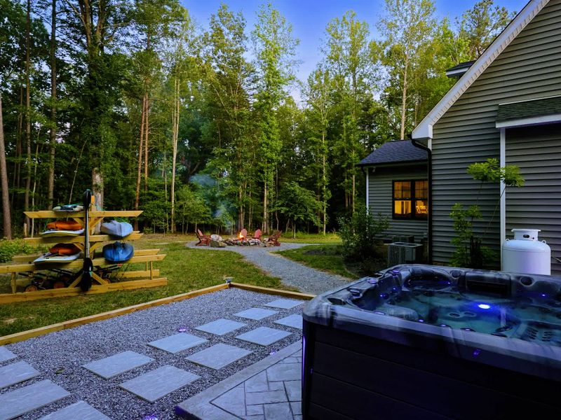 Hot Tub - A twilight soak with the home aglow behind you and the fire pit just steps away.