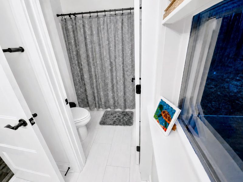 Full Bath - Bright finishes and black fixtures keep this upstairs bath fresh and functional.