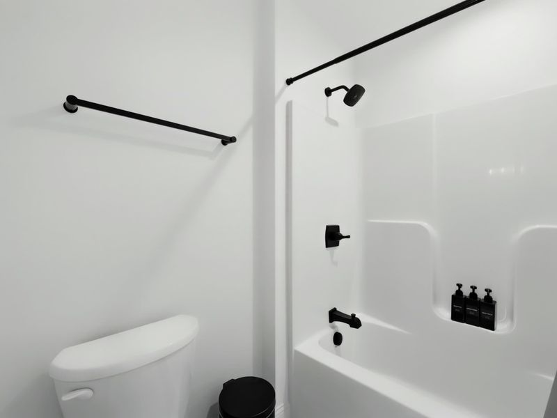 Full Bath - Shower-tub combo with clean tile, stocked and ready for the whole group.