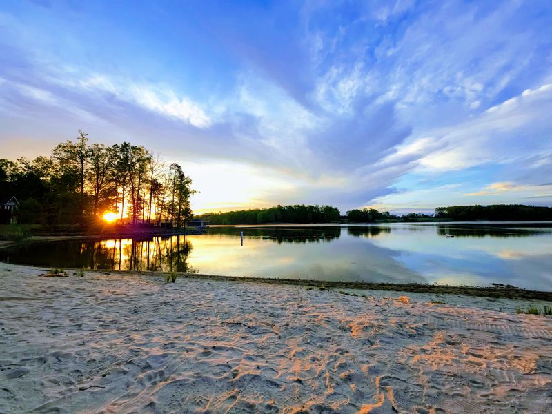 Community Beach - Calm daytime shoreline at the community beach, your launch point for the lake.