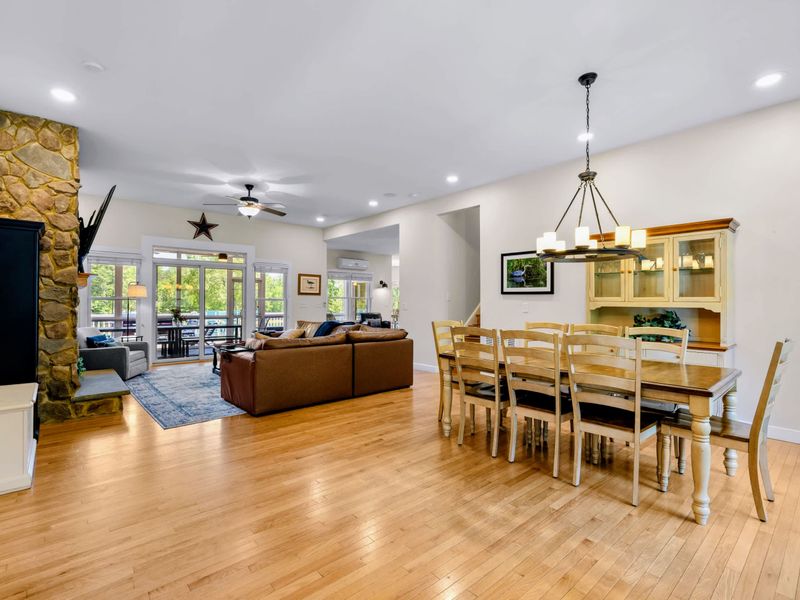 Great Room - Step inside to one wide-open main level, dining table on one side, fireside seating and porch doors on the other.