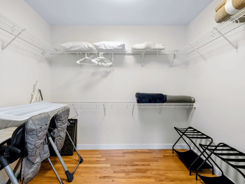 Primary Suite - The walk-in closet comes stocked with spare pillows, luggage racks, and baby gear for little travelers.