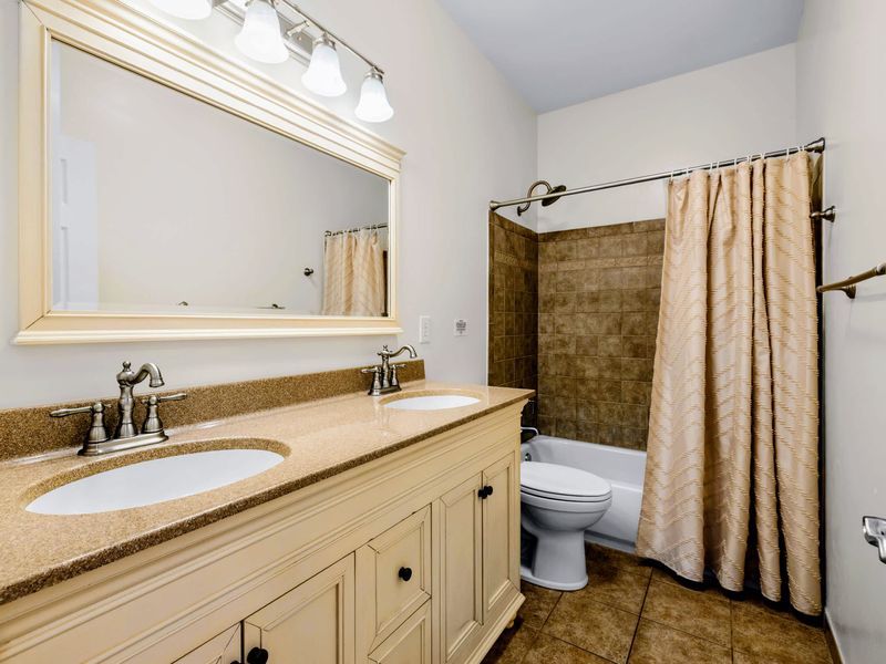 Shared Bathroom - Double-sink vanity plus a tiled tub and shower combo, so there are no morning traffic jams.