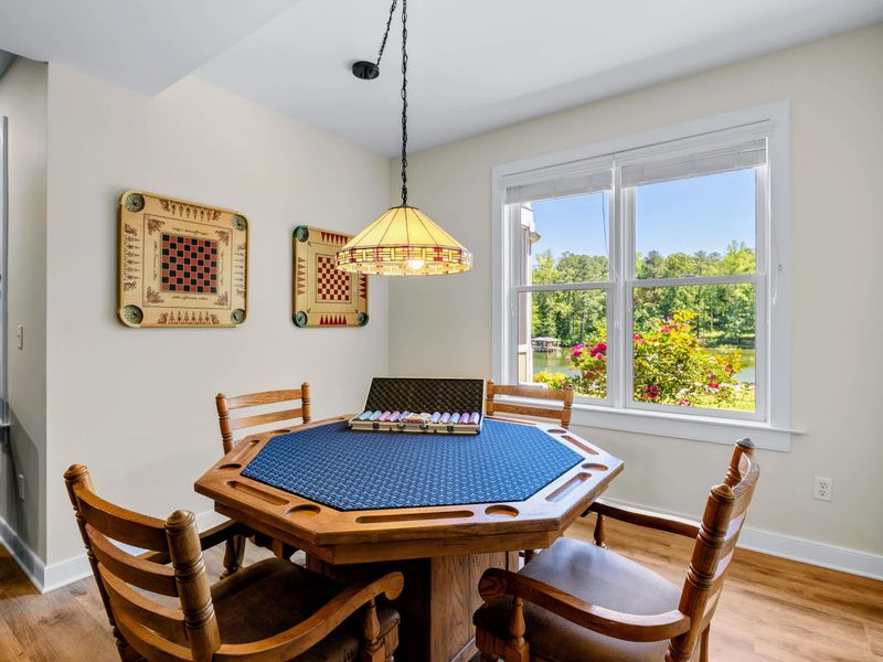 Game Room - The octagonal poker table sits under a stained glass pendant, chips out and a lake glimpse through the window.