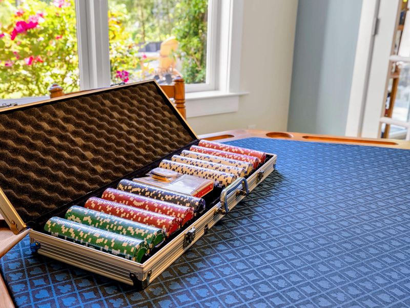 Game Room - A full poker chip set and cards laid out on the speed cloth side of the game table, ready for a high stakes family night.