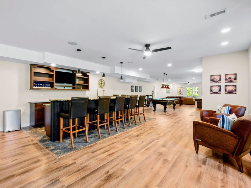 Game Room - Leather stools line the long bar, club chairs wait nearby, and the pool table holds court down the middle.