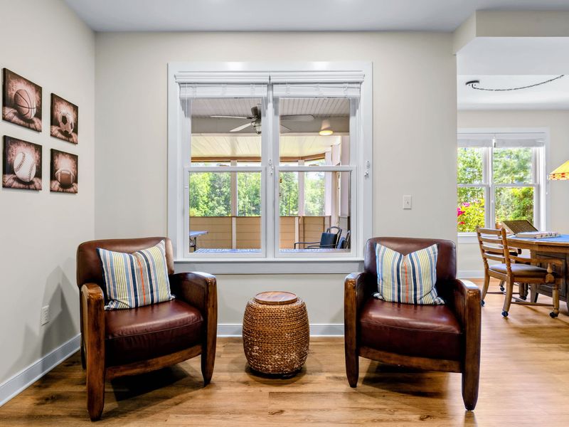 Game Room - A pair of leather club chairs by the windows, with the game table just around the corner.