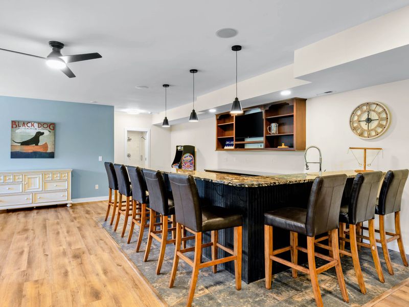 Game Room - The granite wet bar seats a crowd on leather stools, with a TV behind so nobody misses the game.