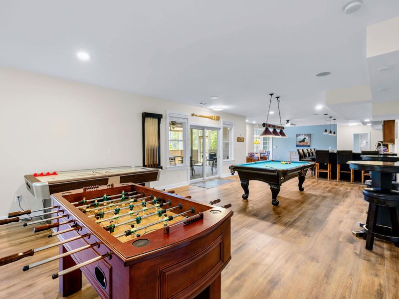 Game Room - Foosball, air hockey and pool fill the open lower level, with doors to the covered patio just steps away.