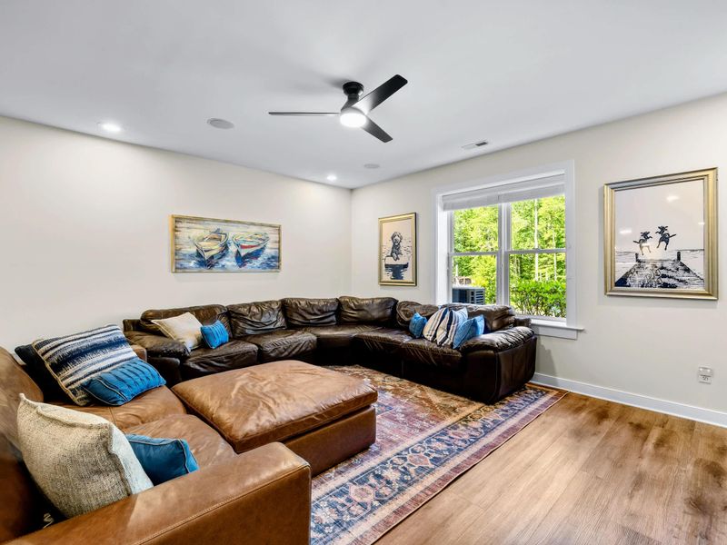 Game Room - Deep leather sectionals and an oversized ottoman make the lounge an easy landing spot after a day on the water.