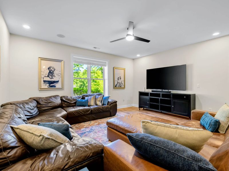 Game Room - Leather sofas wrap the media lounge around a big screen TV, the spot for movie night after a lake day.