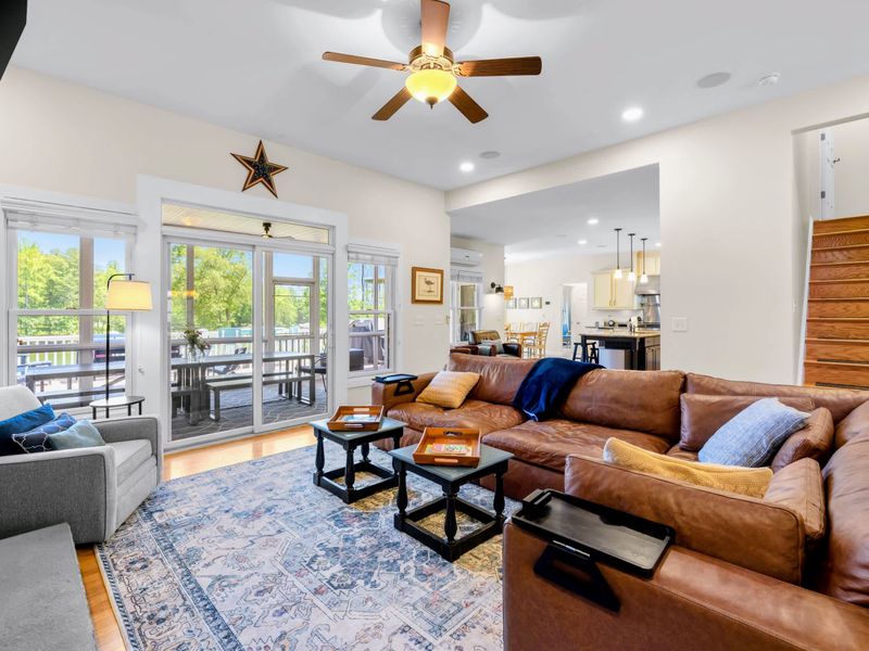 Great Room - Oversized leather sectional at the heart of the open-concept main level, with the kitchen and dining just beyond.