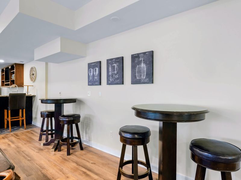 Game Room - Pub tables along the wall give spectators a perch between the pool table and the bar.