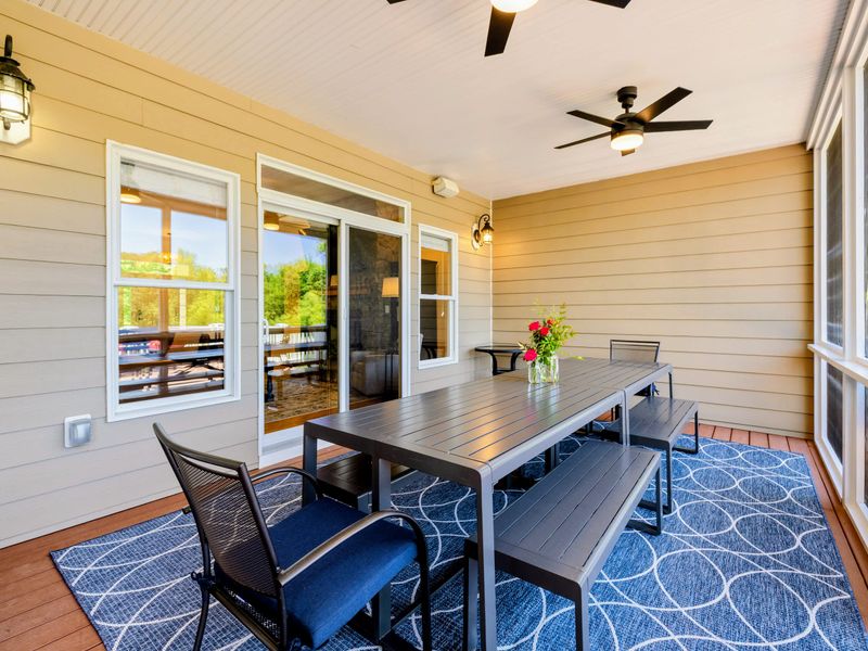 Deck and Porches - Dine outdoors off the great room sliders, with bench seating, ceiling fans, and screens to keep evenings comfortable.