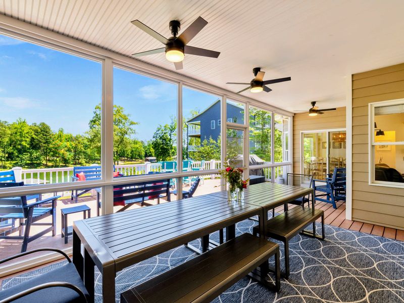 Deck and Porches - Long screened porch dining table with bench seating and ceiling fans, ready for big group dinners.