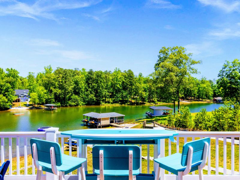 Deck and Porches - High-top table seating right at the railing, with a wide lake view over the cove and boathouses below.