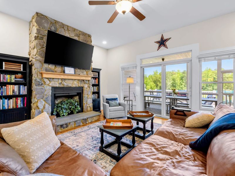 Great Room - Sink into the leather sectional by the stone fireplace, with porch doors letting the outside in.