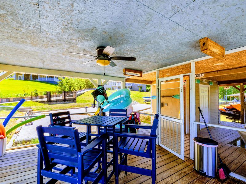 Lakefront - Floats and pool noodles stock this covered hangout, with a table for snacks between rounds on the water.