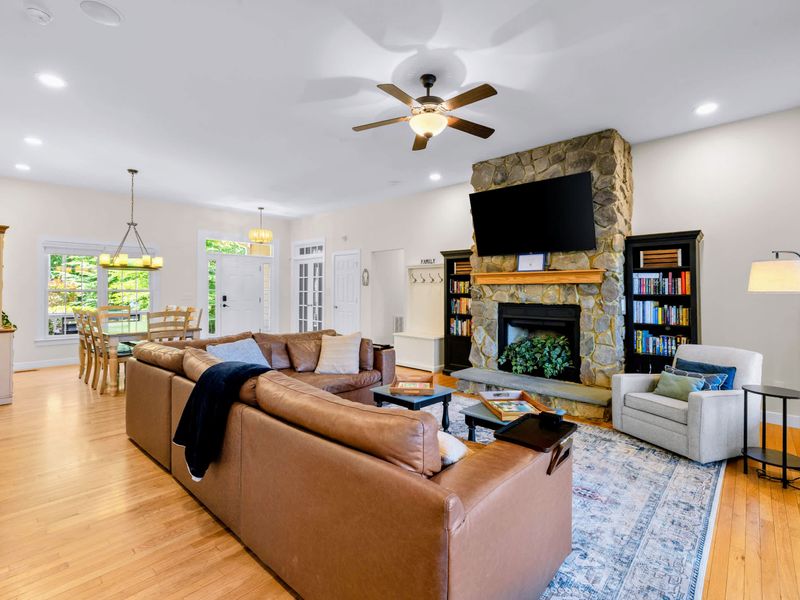 Great Room - The main level flows from sectional and hearth to the dining table, all in one bright open space.