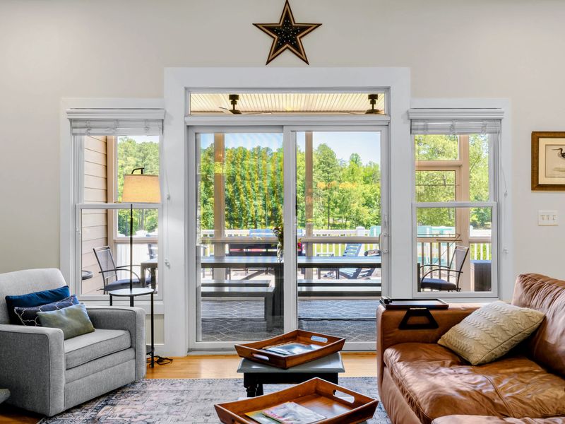 Great Room - Sliders open straight onto the screened porch, blending indoor lounging with outdoor dining in one step.