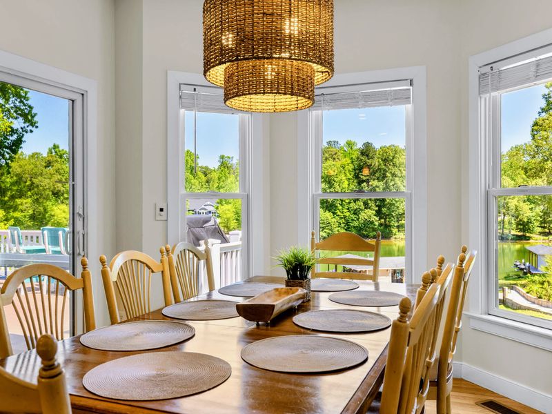 Dining Area 2 - Woven pendant lighting and wraparound windows give this table a bright lake view backdrop for casual meals.