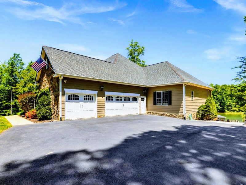 Exterior - Wide driveway with room for the whole crew to park, lake glimpses just past the garage.