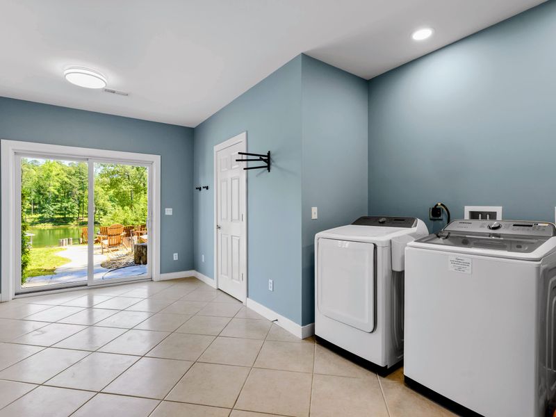 Lower Level Laundry - Full-size washer and dryer beside sliding doors that open straight to the lawn and the lake.