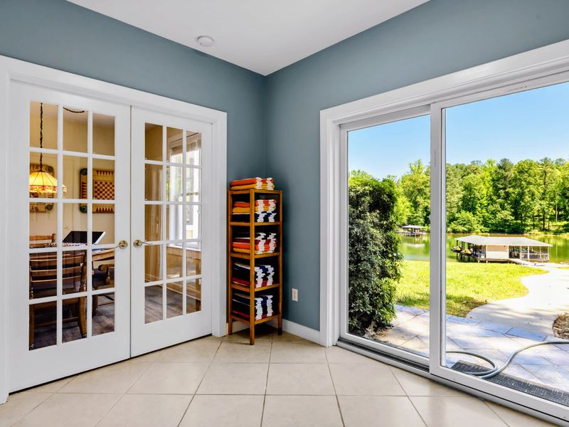 Lower Level Laundry - Towel shelf kept stocked, with French doors to the game table and a slider overlooking the lake.