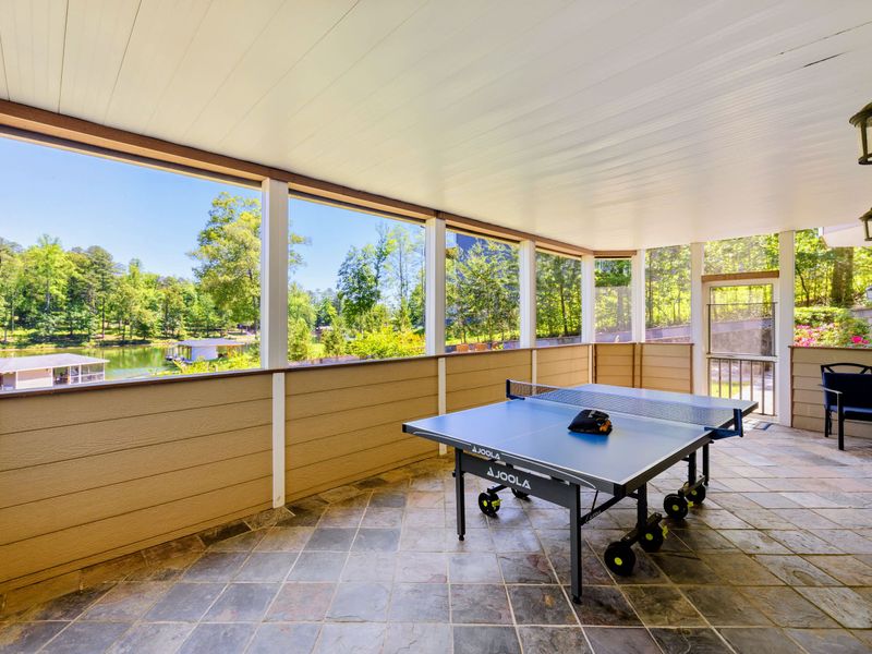 Patio - Rally at the ping pong table with water views just beyond the screened openings.