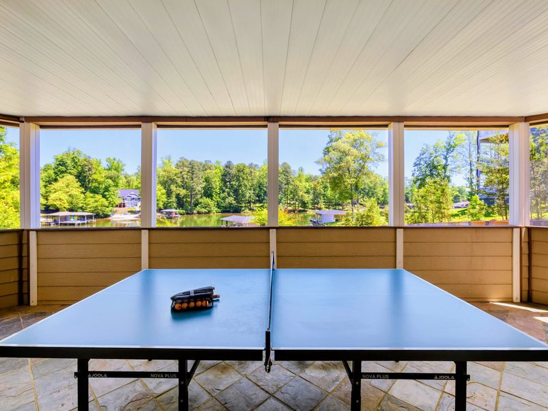 Patio - Ping pong table ready on the screened porch, with cove views just beyond the screens.