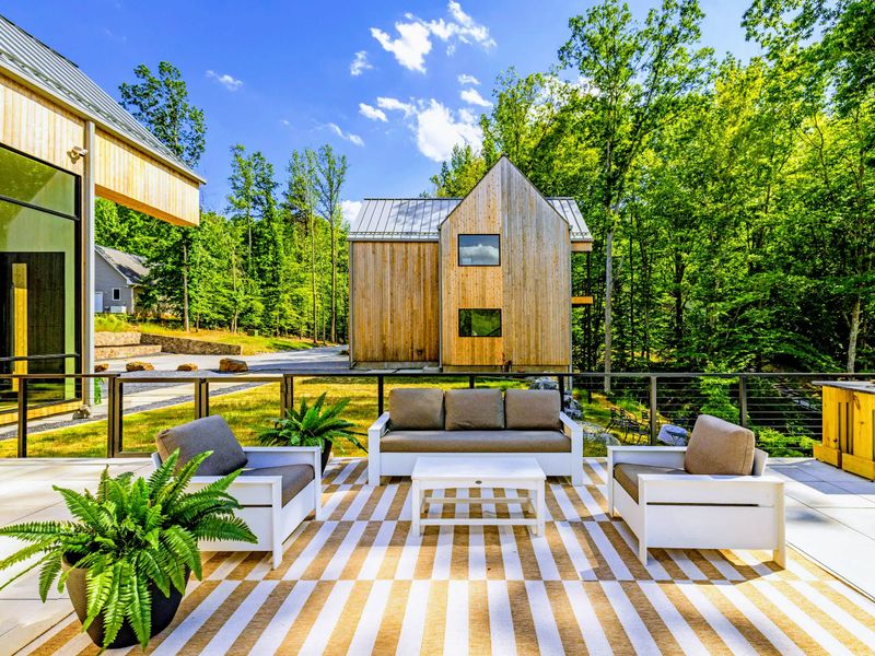 Sunset Patio - Deep lounge seating on the open-air deck, framed by cedar and forest, made for unhurried evenings outside.