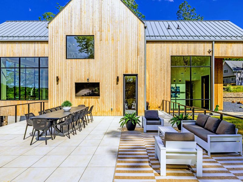 Sunset Patio - Modern concrete and cedar frame an outdoor lounge built for the whole group.