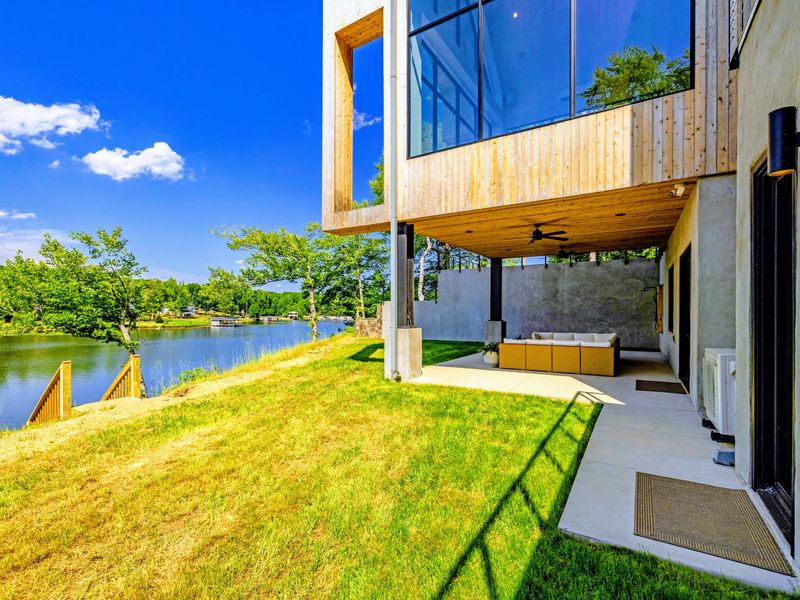 Covered Patio - Sheltered lounge seating beneath the cantilevered great room, lake views with shade from the midday sun.