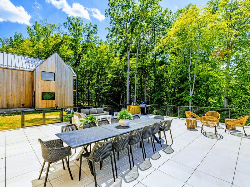 Sunset Patio - Sectional seating set against the cedar facade and the trees.