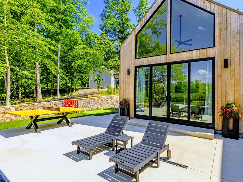 Pool - The 30-foot pool sits beneath the home's glass-and-cedar architecture, a resort built into the forest.