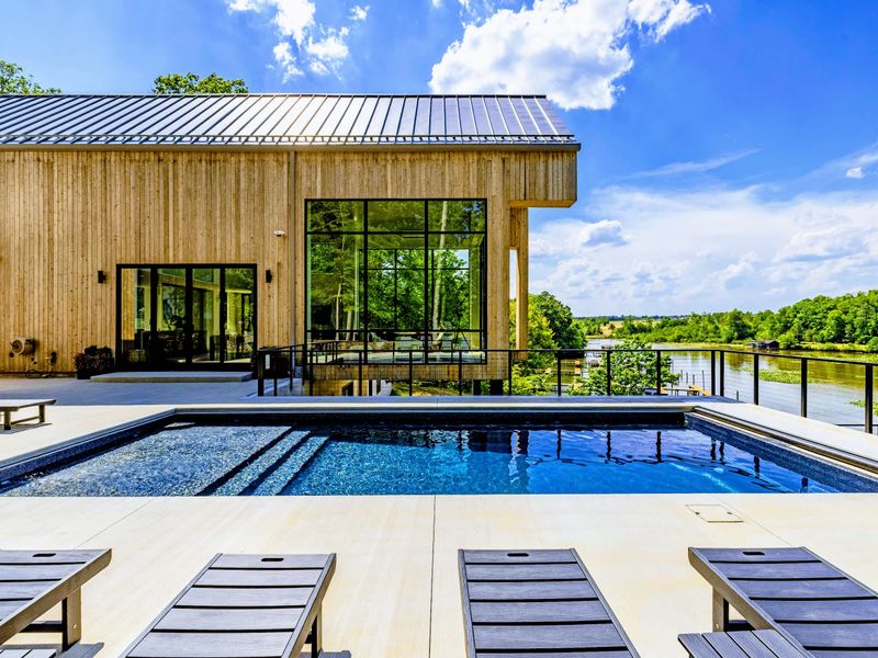 Pool - Evening light settles over the water and the cedar walls beyond.