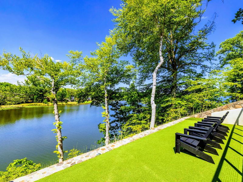 Lakefront Lawn - Open grass runs gently down to the shoreline, bare feet and lake views included.