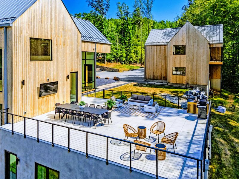 Aerial View - Pool, decks, and the cantilevered great room seen from the sky.