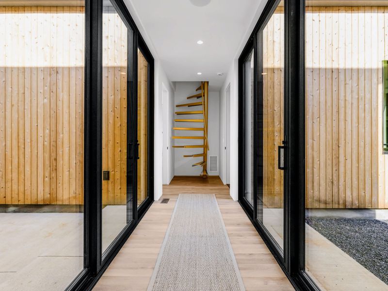 Library Suite - A glass-walled passage leads to the upper-level guest room.