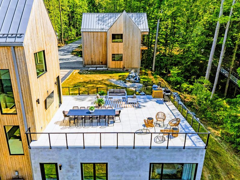 Exterior - Pool, loungers, and the cedar facade against the Virginia pines.