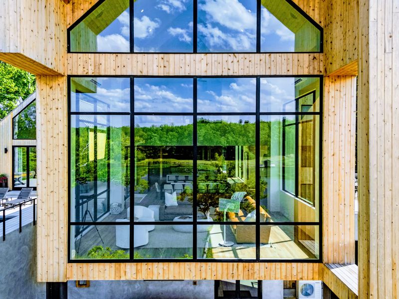 Exterior - A glass corner of the home opens to the deck and the trees.