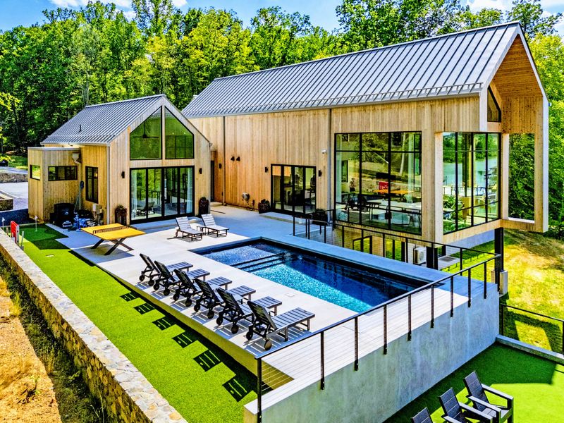Aerial View - The pool and home from above, tucked into the treeline.