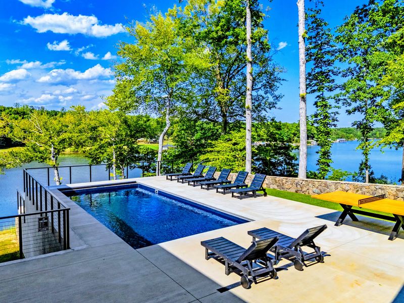 Pool - The pool and shoreline from above, blue water against the forest canopy.