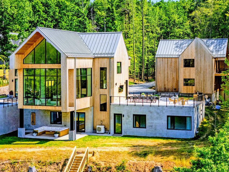 Exterior - The signature glass gable faces the water and the evening light.