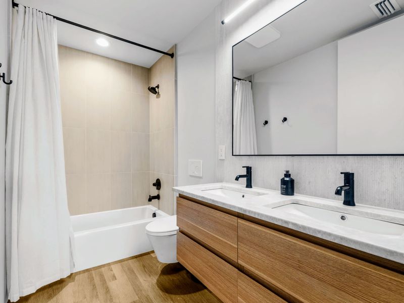 Garage Apartment Bath - A tub-and-shower and double vanity serve the guest apartment.