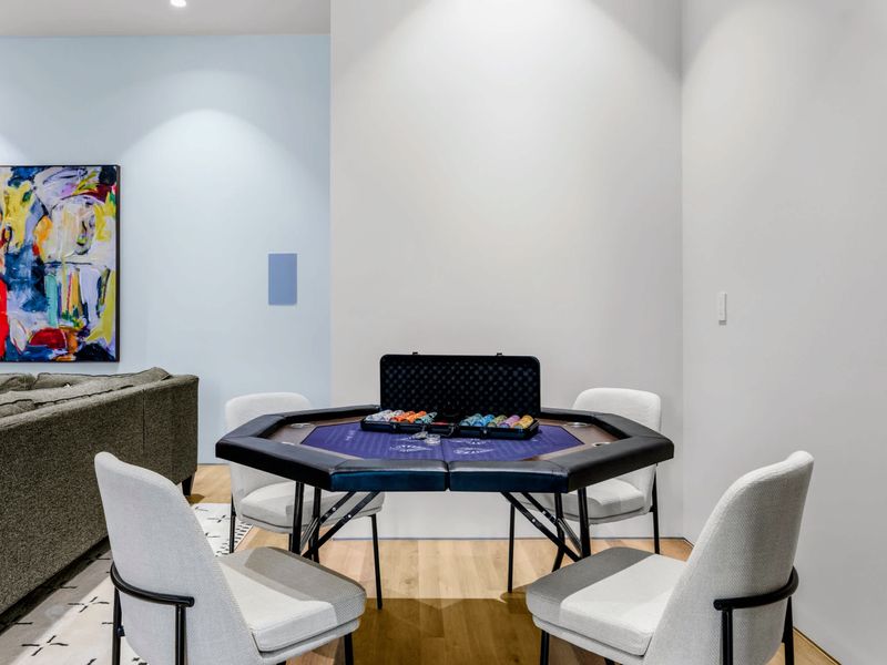 Game Room - The poker table waits under clean lines for a competitive evening.