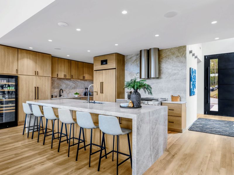 Chef's Kitchen - The oversized island with bar seating is the natural gathering point.