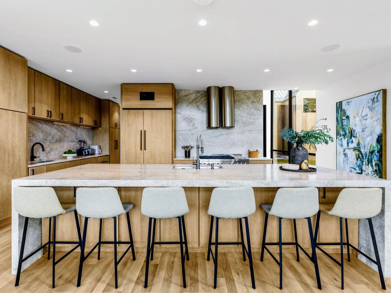 Chef's Kitchen - A long island and pendant lighting anchor the open main level.