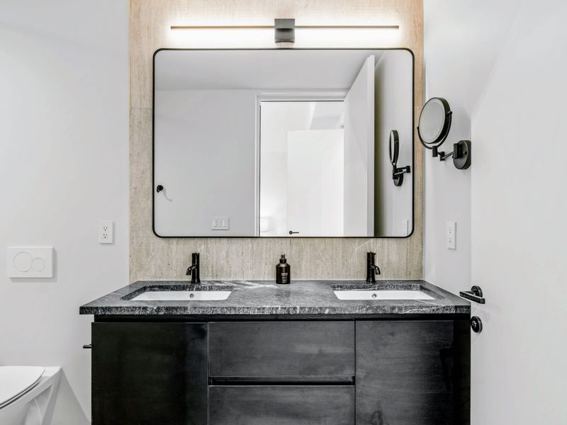Upstairs King Suite - A double vanity and clean stone finish the private bath.